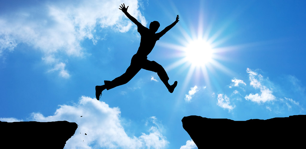 person jumping from ledge to ledge