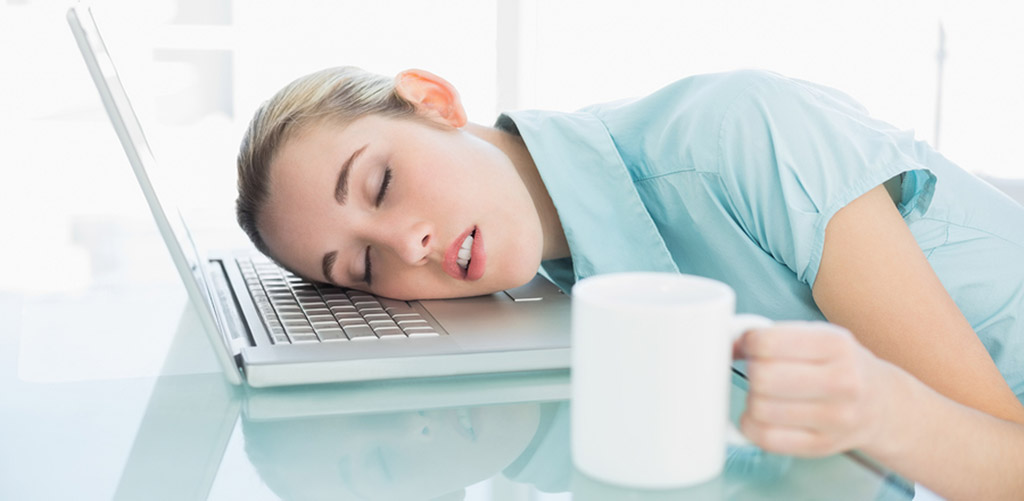 girl sleeping on computer