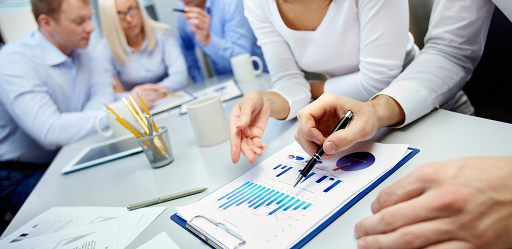 people pointing at a information graph
