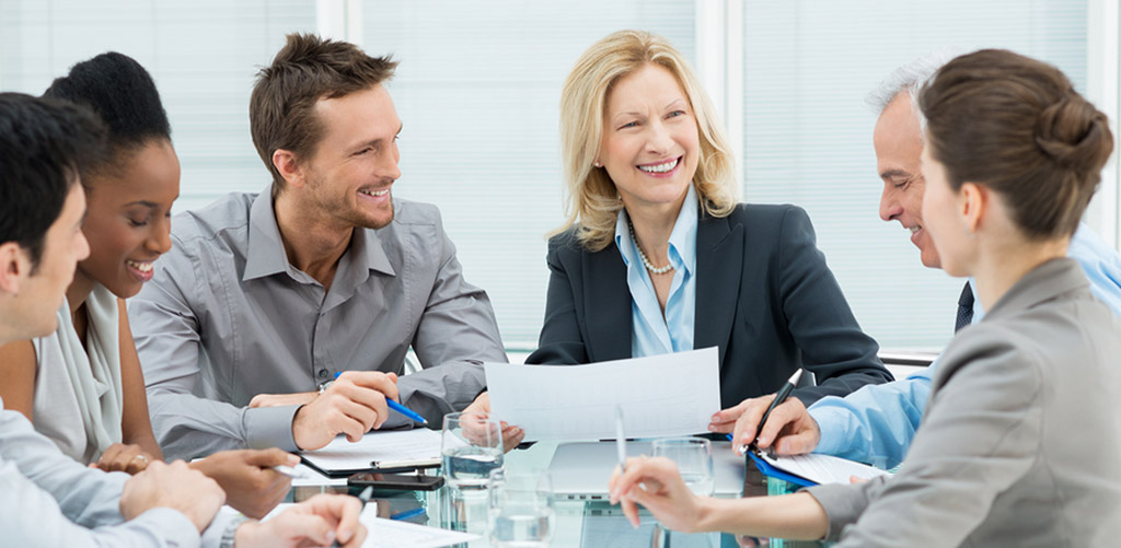 6 co-workers chatting about business