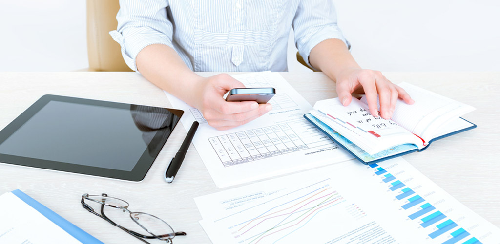 person sitting at desk with marketing material