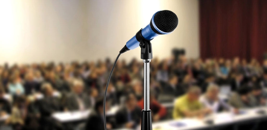 microphone in front of room of people
