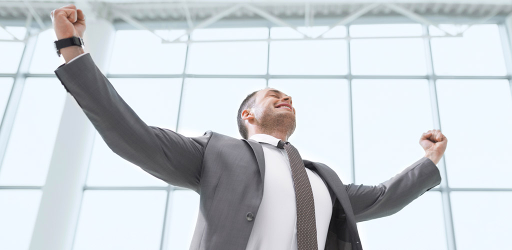 man with his hands in the air from success